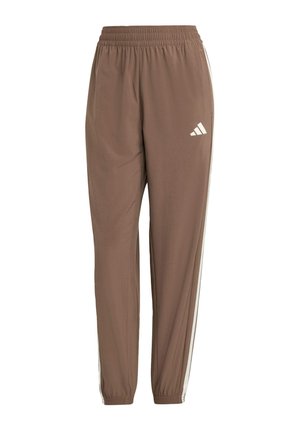 Pantalons de sport marron en matériau léger, avec une coupe fuselée, une taille élastique et des bandes latérales blanches avec le logo Adidas.