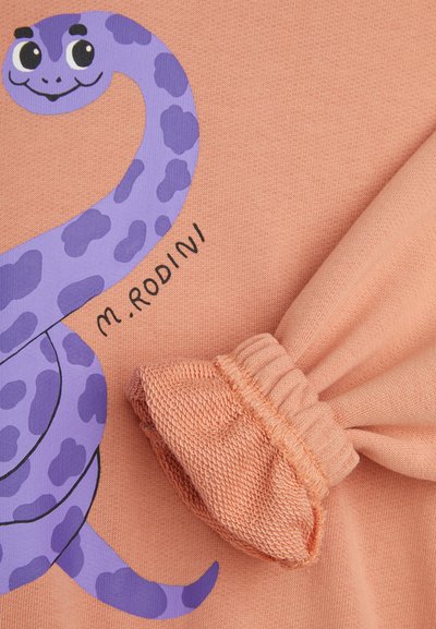 Peach-colored fabric with a purple snake design. Features gathered fabric detail on the side. Brand name "M. Rodini" visible.