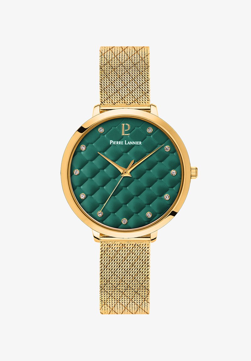 Zelta tonī pulkstenis ar zaļu kviltotu ciparnīcu, kas rotāta ar dimanta līdzīgiem akcentiem, zelta rādītājiem un sietveida jostu. Eleganta apaļa forma ar detalizētu tekstūru.