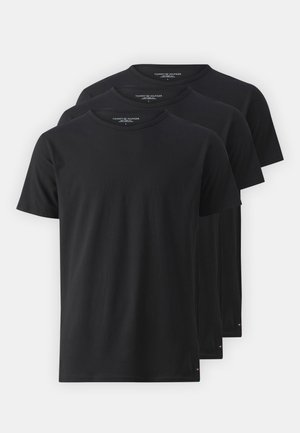 Drei schlichte schwarze T-Shirts mit kurzen Ärmeln und Rundhalsausschnitt, übereinandergestapelt, jeweils mit kleinem Tommy Hilfiger-Logo am unteren linken Saum und Etikett am inneren Nacken.