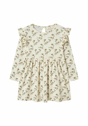 Robe à manches longues couleur crème avec un motif floral, dotée d'épaulettes à volants et d'un dos avec une ouverture en forme de goutte. Fabriquée en tissu côtelé.