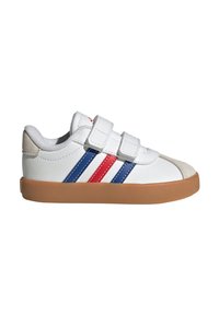 Zapatillas blancas para niños con tres rayas azules y rojas, correas de Velcro y una suela de goma beige. Parte superior de cuero texturizado y cuello acolchado.