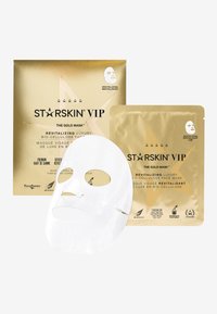 Masque facial en bio-cellulose de luxe revitalisant en blanc, emballé dans une boîte dorée avec texte noir et accents d'étoiles. Design pratique pour le voyage.