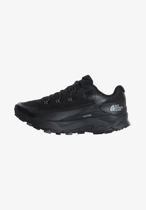 Black athletic shoe featuring a breathable mesh upper, rubber sole, textured accents, and reinforced toe cap for durability.