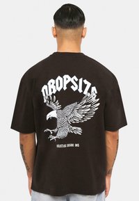 Black cotton t-shirt featuring a large white eagle graphic on the back, with the text "DROPSIZE" and "HUNTING SEASON 365" below it.