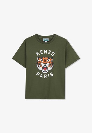 T-shirt in cotone verde oliva con vestibilità oversize; presenta una grafica stampata di una tigre e il testo "KENZO PARIS" in bianco intorno ad essa. Maniche corte.