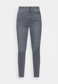 Pantalones ajustados de mezclilla gris oscuro, con una cintura alta, bolsillos frontales y una cremallera con cierre de botón. Textura suave, sin patrones visibles.