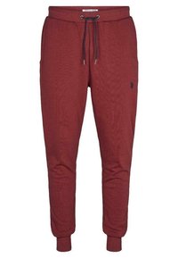 Mörkröda sweatpants i mjukt tyg, med elastisk midja och dragsko, sidofickor och ribbade muddar. Litet logodetalj närvarande.
