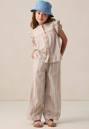 Striped outfit with a sleeveless top featuring ruffles, button closure, and wide-leg pants. Accessories include a blue bucket hat with colorful hearts.