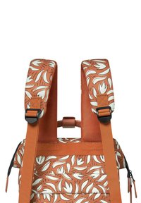 Orange fabric backpack with white floral pattern, adjustable padded straps, and black hardware accents. Zippered compartments visible.