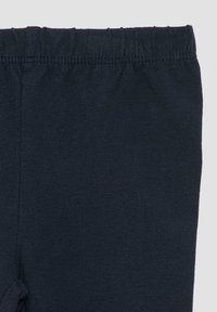 Leggings bleu marine en tissu mélangé coton, dotés d'une taille douce et d'une texture lisse, sans motifs ni accents visibles.