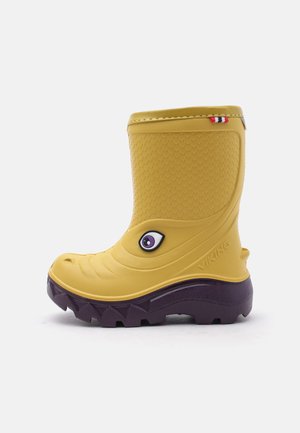 Botte de pluie pour enfants jaune et violet foncé avec tige texturée, motif ludique en forme d'œil sur le côté et semelle épaisse à crampons.