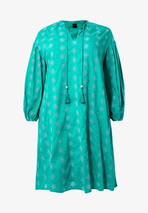 Tegengesteld van katoen in turquoise met lange mouwen, een V-hals, bloemenborduursel en kwastjes langs de halslijn. Relaxte pasvorm en knielang.