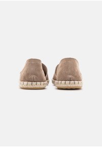 Brown suede espadrilles with a woven jute sole and a rounded back. Features a soft texture and minimalist design.
