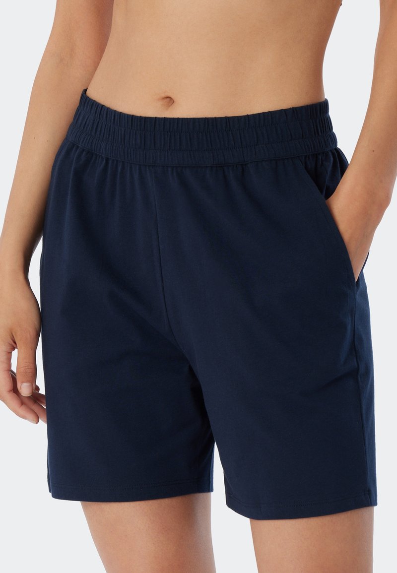 Marina blå bomullsshorts med elastisk midja och sidofickor, med en avslappnad passform och mjuk textur.