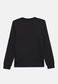 Črna dolga majica z dolgimi rokavi iz bombaža. Ima okroglo ovratnico in rebraste manšete. Gladka tekstura, brez vzorcev ali dodatnih detajlov.