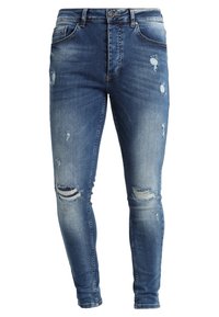 Blå denim skinny jeans med slitet detaljer, inklusive rivna knän, whiskeringeffekter och en klassisk femfickdesign.