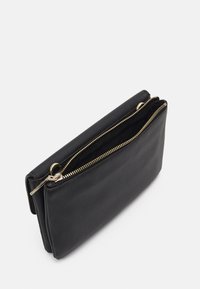 Calvin Klein RELOCK CROSSBODY BAG - Umhängetasche - black