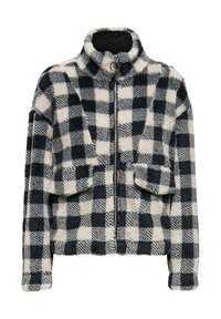 Veste en flanelle duveteuse à col haut, avec un motif à carreaux noir et blanc, fermeture éclair complète et deux poches frontales. Texture douce.