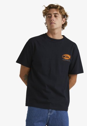 Navy blue cotton t-shirt with a crew neck, short sleeves, and a small orange logo on the left chest. Smooth texture, relaxed fit.