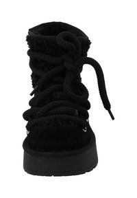 Black lace-up boot with a suede exterior, textured upper, thick sole, and prominent lacing detail. Features metal eyelets and soft lining.