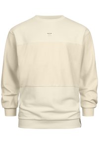 Sudadera color crema hecha de una tela suave. Cuenta con cuello redondo, mangas largas y un panel central con una pequeña etiqueta de logo.