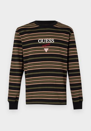 Langermet stripete skjorte i svart, oliven grønn og rosa. Har brodert "GUESS" og triangel-logo på brystet. Myk stoff.
