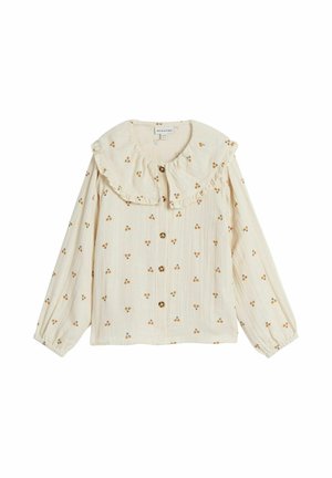 Cremefarvet bluse med flæsekrave, prydet med små blomster mønstre. Har knapper ned foran og lange, elastiske ærmer.