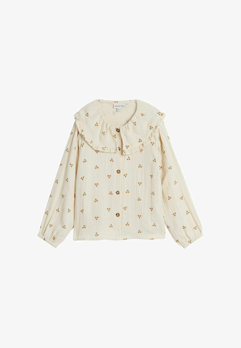 Cream-colored blouse with a ruffled collar, adorned with small floral patterns. Features buttons down the front and long, elasticized sleeves.