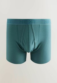 Férfi boxer alsónadrág türkiz színben, texturált derékkal. Simább anyagból készült, testhezálló fazon, középen elhelyezkedő zsebbe, amely extra támaszt nyújt.