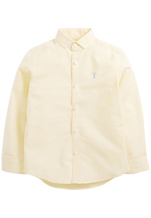 Chemise à manches longues jaune pâle à boutons, avec col et petit logo bleu brodé sur la poitrine gauche.