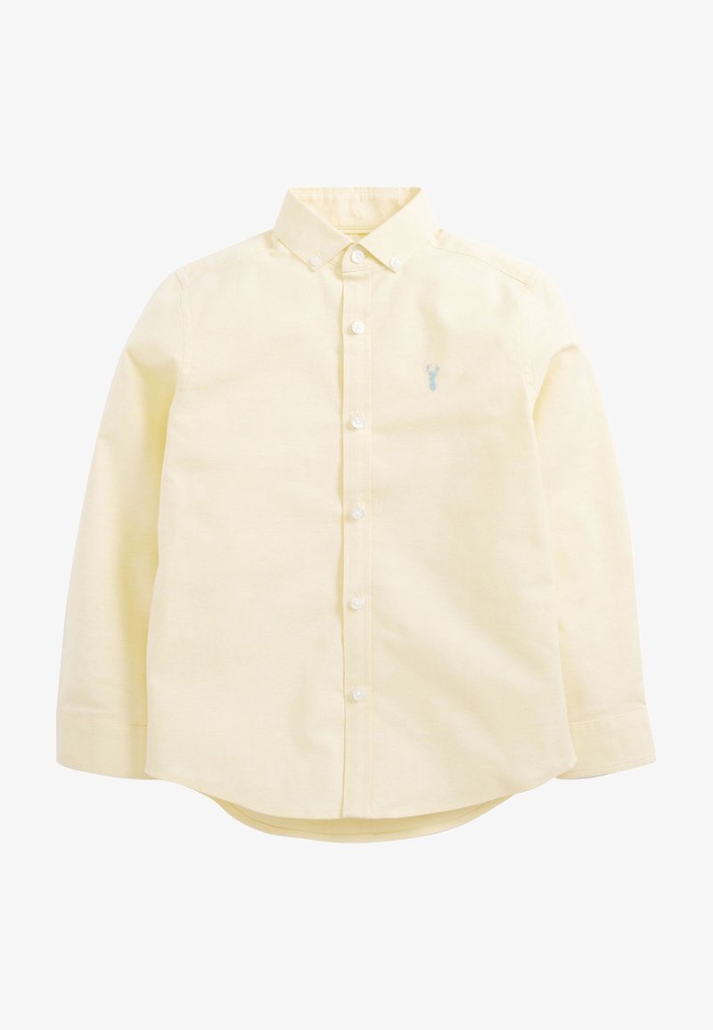 Chemise à manches longues jaune pâle à boutons, avec col et petit logo bleu brodé sur la poitrine gauche.