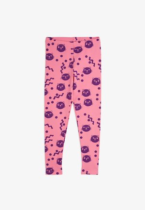 Rosa leggings med et gjentakende mønster av lilla katteansikter, bølgete linjer og prikker. Laget av et elastisk, mykt materiale.