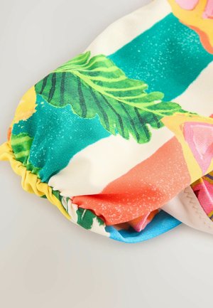 Mitmevärviline kangas troopilise mustriga, millel on rohelised lehed, roosad ja kollased aktsendid ning kogutud servade detail. Sile tekstuur.