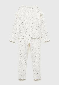 Valkoinen pyjamapuku, jossa on pitkät hihat ja housut, mustalla tähtikuosisella, hattu keskustakuvioilla ja pehmeällä, sileällä tekstuurilla.