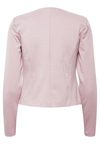 Blazer ajusté à manches longues de couleur rose clair avec des détails de couture et une coupe légèrement raccourcie, présenté de dos sur un fond blanc.