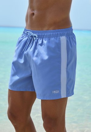 Light blue swim trunks with an elastic waistband, drawstring, and white side panel. Fabric appears smooth and water-resistant. "H.I.S." logo present.