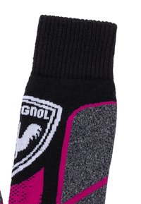 Chaussette de sport noire, grise et magenta avec un poignet côtelé et un logo blanc représentant un aigle stylisé et le mot "RAVAGNOLI."