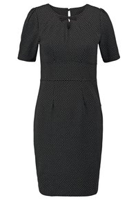 Robe noire longueur genou avec manches courtes, petits pois blancs, taille cintrée, encolure en trou de serrure et petit nœud au niveau du cou.