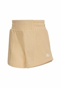 Beige idrottsshorts med en bred, texturerad midjeresår, sömlösa sidofickor och en liten vit Adidas-logotyp på nedre högra sidan.