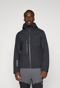 Black waterproof jacket with a zippered chest pocket and adjustable hood, featuring a sleek, smooth texture and minimalistic design.