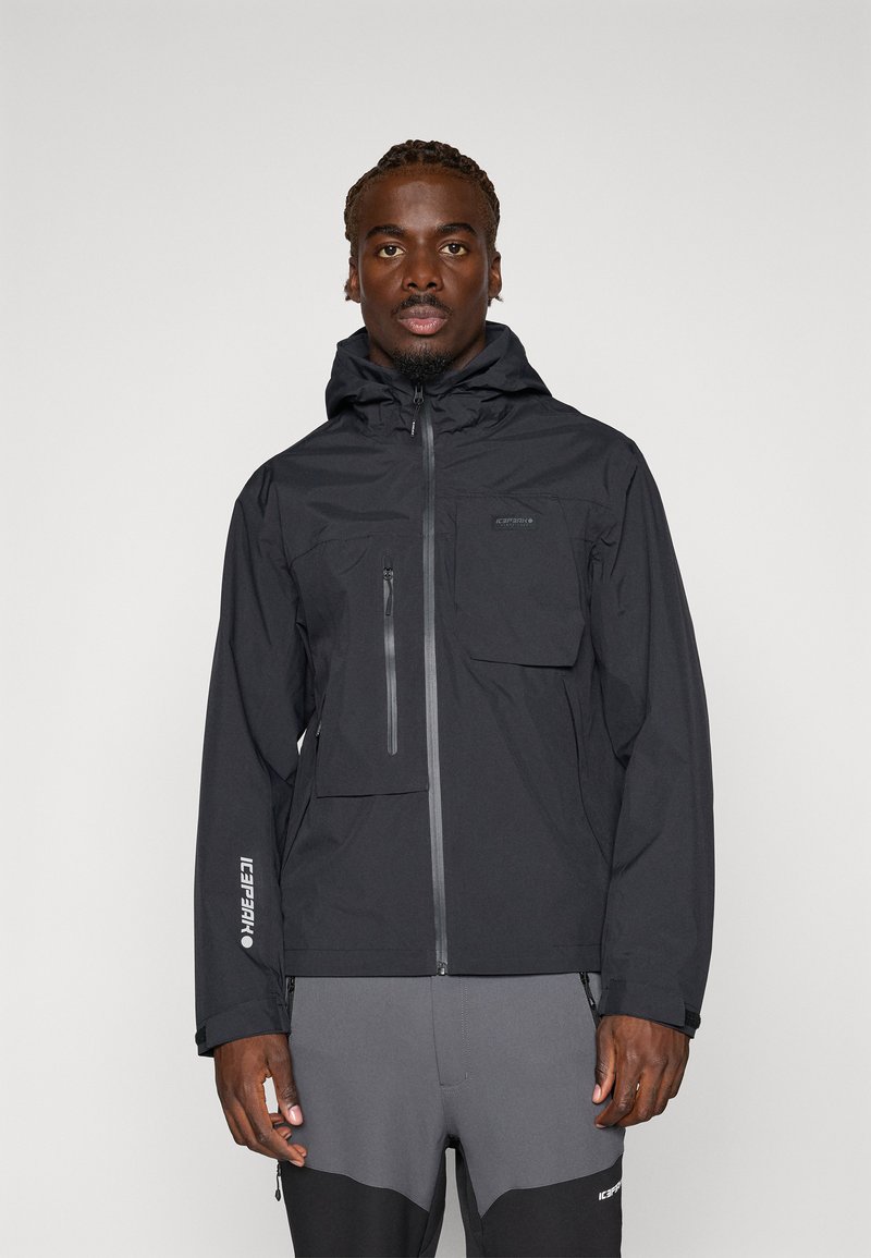 Black waterproof jacket with a zippered chest pocket and adjustable hood, featuring a sleek, smooth texture and minimalistic design.