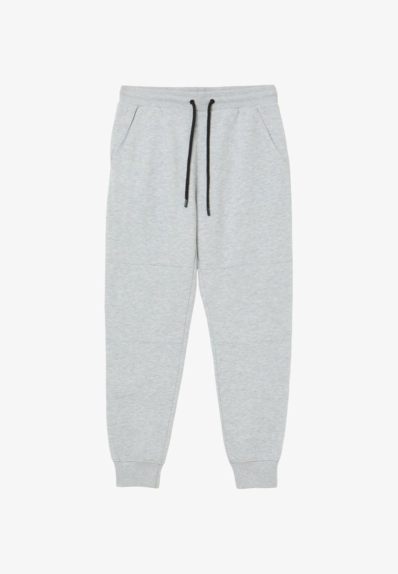 Pantalons de survêtement gris clair en tissu doux, avec une taille à cordon de serrage, des poches latérales et des poignets resserrés aux chevilles.