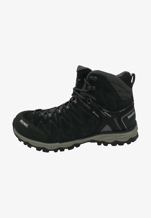 Zwarte wandelschoen van suede met mesh accenten. Beschikt over een robuuste buitenzool, versterkte neuskap en een vetersysteem voor een veilige pasvorm.