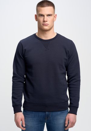 Felpa blu navy in misto cotone. Collo a giro, polsini e orlo a costine, con un leggero dettaglio a V nella zona del collo.