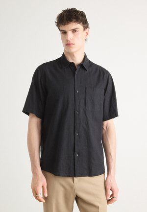 Black short-sleeved shirt in a textured fabric, featuring a button-up front and a chest pocket. The collar is classic and structured.
