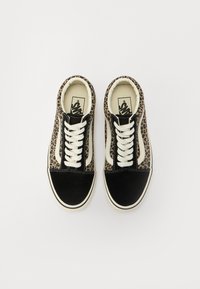 Black sneakers featuring a leopard print design, lace-up closure, suede material, and a contrasting black toe cap with white stitching.