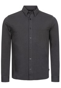 Tummanharmaa pitkähihaisen paidan nappikiinnitys. Ominaisuuksiin kuuluu klassinen kaulus, edessä napit ja sileä puuvillasekoitekangas, jossa on hienovarainen tekstuuri.