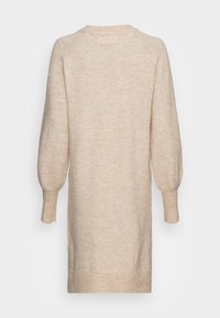 Abito maglia di colore beige chiaro. Presenta un collo rotondo, maniche lunghe a sbuffo e polsini a coste con bordo dritto. Texture morbida con un motivo sottile.