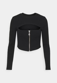 Top nero cropped a maniche lunghe con scollatura rotonda, dotato di chiusura con zip frontale e un'apertura tagliata sotto il collo.